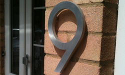 modern house numbers on red brick